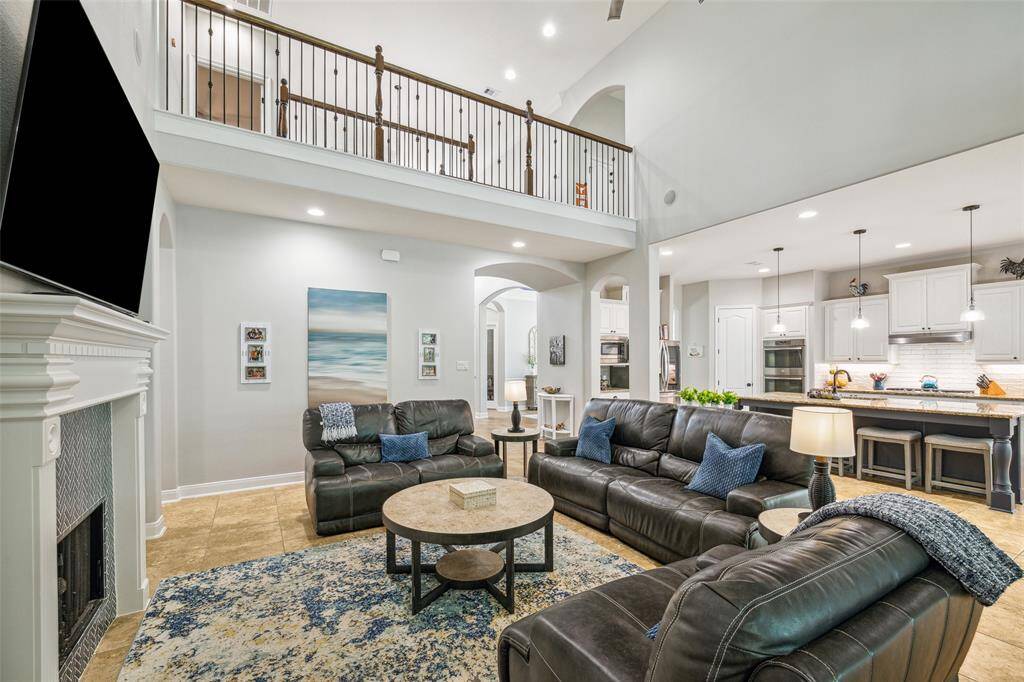 A spacious, open-concept living room opens to the kitchen and breakfast area.
