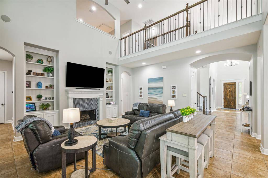 Living area with built ins and a gas fireplace