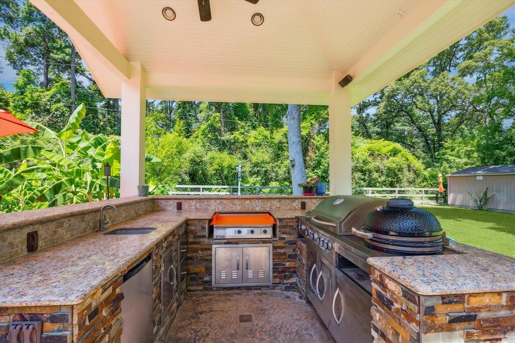 Entertain your guests and family with this fabulous outdoor kitchen w/refrigerator, sink, gas grill and smoker