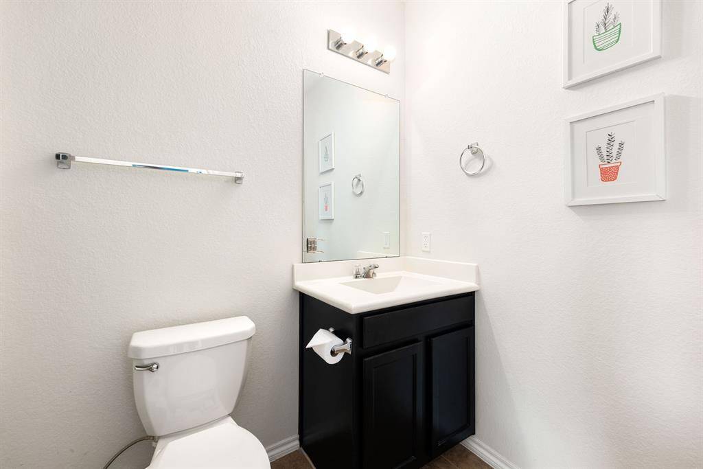 Perfectly placed for convenience, this chic powder room is both functional and inviting—an ideal complement to any home.