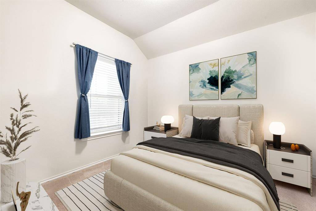 Secondary bedroom features plush carpet, neutral paint, and a large window with privacy blinds.