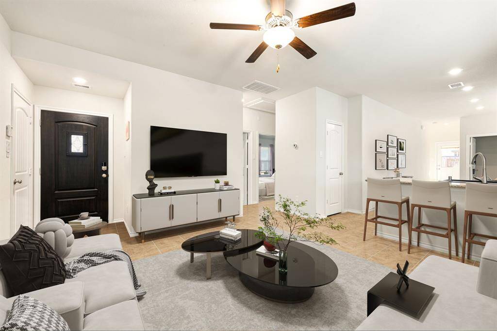 Step into modern elegance with this stunning open-concept living space, where high ceilings and recessed lighting create an airy ambiance. The seamless flow from the inviting living area to the stylish kitchen, featuring a spacious island and sleek countertops, makes this home perfect for both relaxation and entertaining. A neutral color palette and beautifully tiled floors enhance the sophisticated design, while large windows invite abundant natural light.
