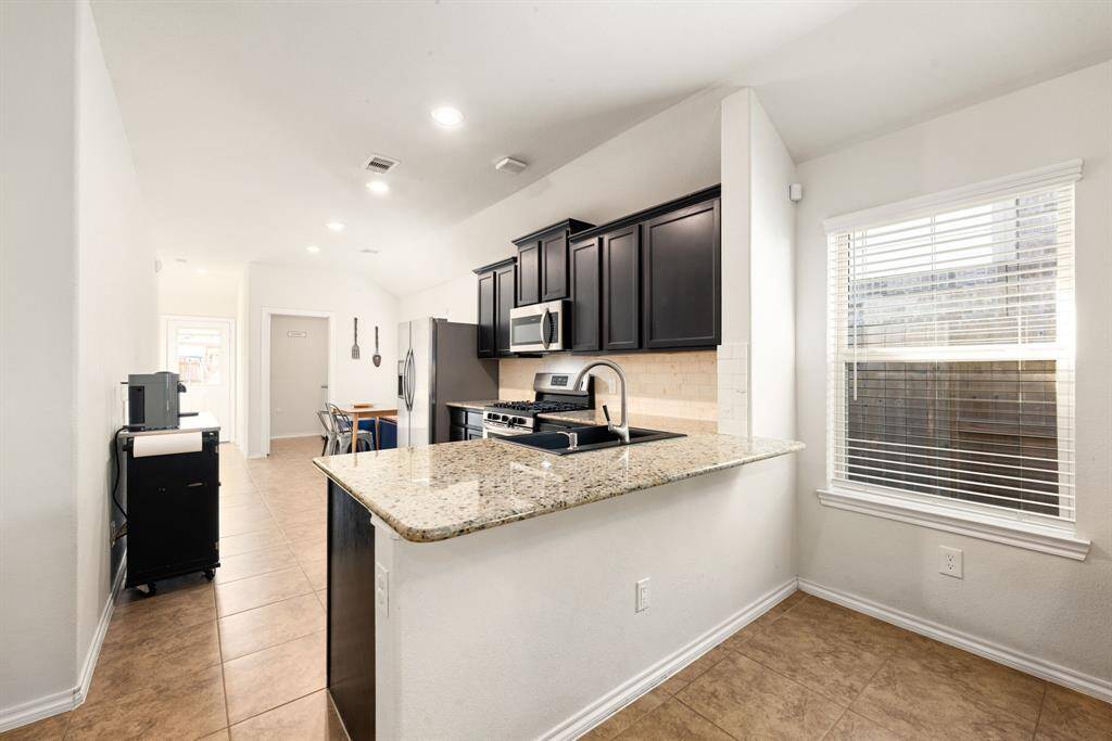 Any chef's dream, this stunning kitchen is perfect for everyday life as well as entertaining family and friends! Extra large breakfast bar is perfect for conversation or that much needed space to lay out your party spread for everyone to enjoy! Large windows provide plenty of natural lighting throughout the day.