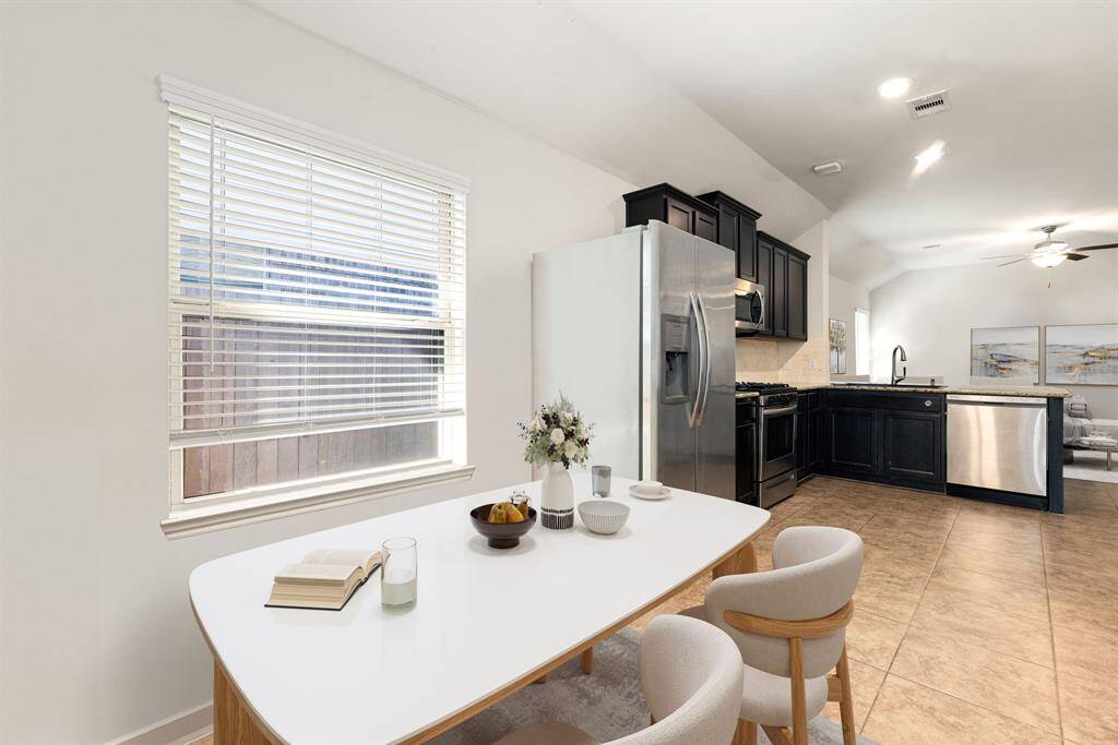 This lovely breakfast area is perfect for starting the day out on the right foot.  This space showcases high ceilings, recessed lighting, large window adding to the ample natural light in the kitchen, and tile flooring.