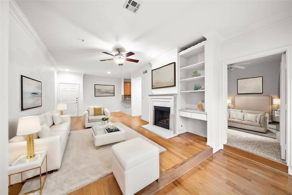 Virtually Staged - The open-concept layout features high ceilings, crown molding, and a modern kitchen with stainless steel appliances, a large breakfast bar, and ample cabinet space—perfect for casual dining and entertaining.
