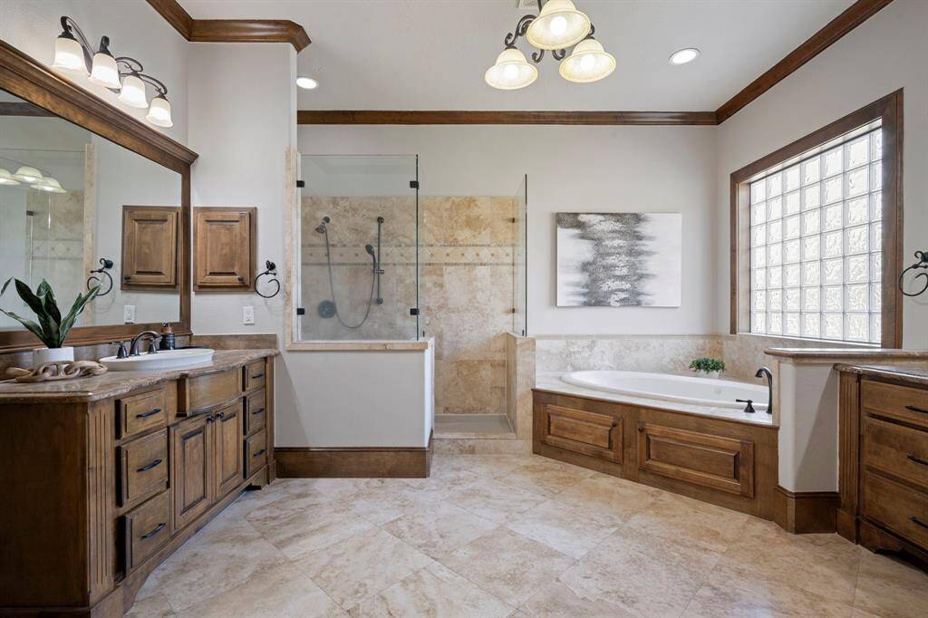 Primary bathroom with two sinks, large tub and walk in shower