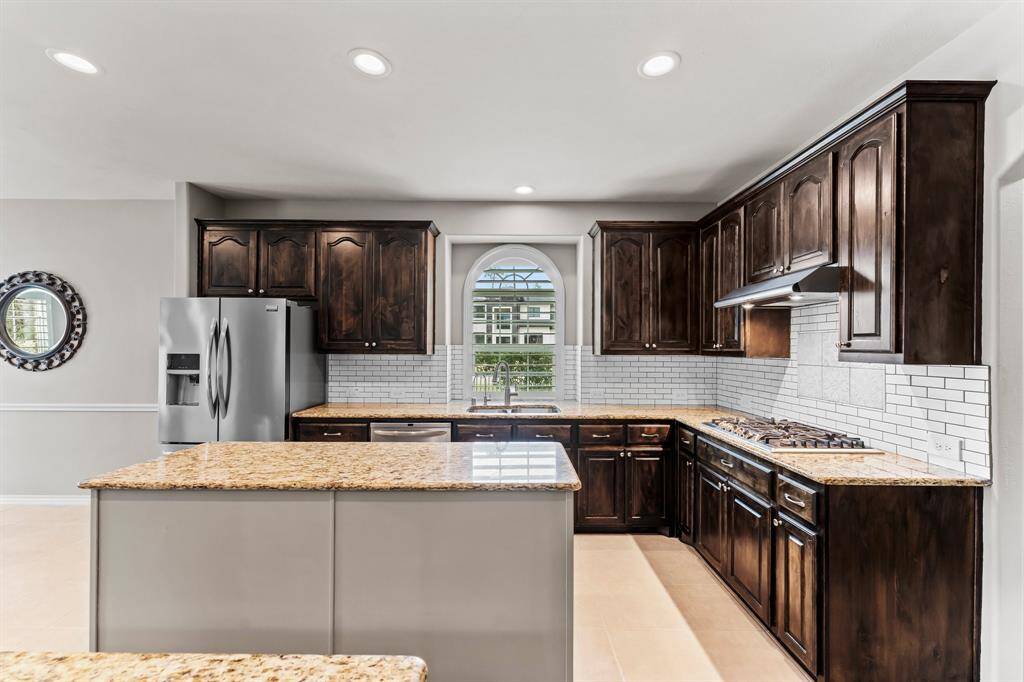 The kitchen offers plenty of cabinet storage and tons of counter space for all your meal prepping and serving. The refrigerator is included with the home.