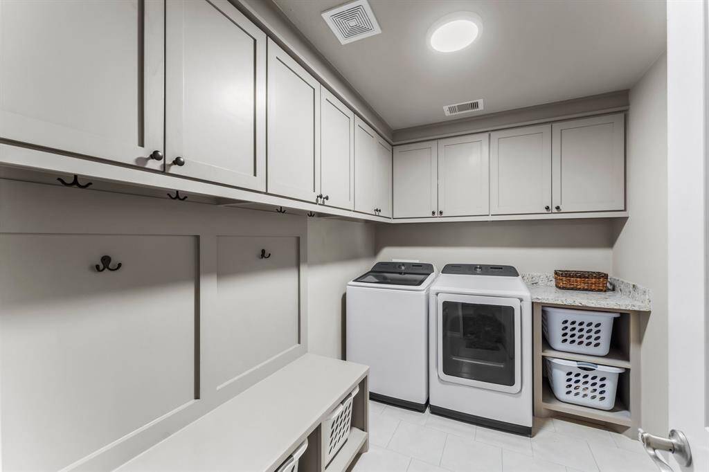 The laundry room is accessed by the 2 car attached garage. The washer and dryer are included with the home.