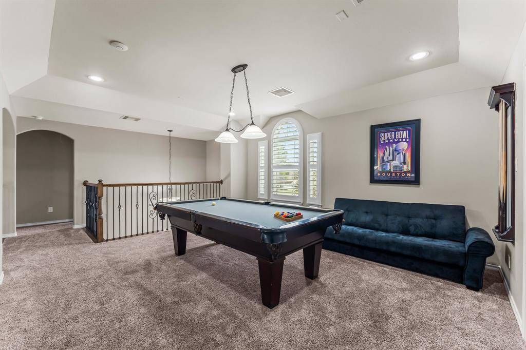 Just at the top of the stairs is the gameroom with a view of the front lawn.