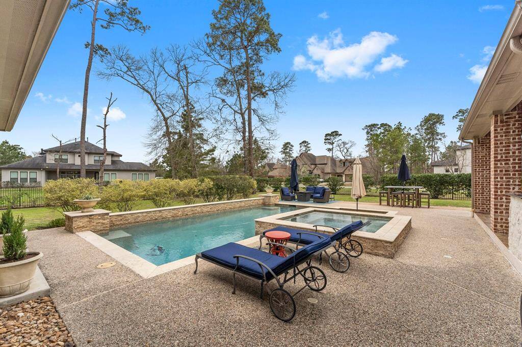 The large pool, hot tub and all the places to relax make this backyard exceptional!
