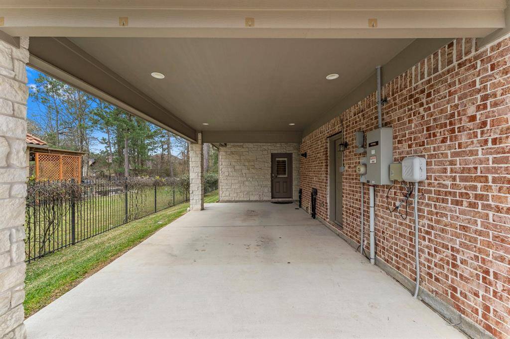 The covered porte-cochere offers access to the one bay garage and the Guest Home.