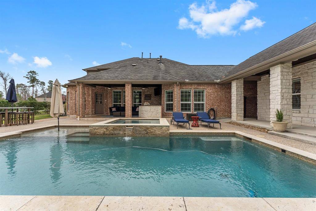 The covered patio off the back of the main home features plenty of covered outdoor living and an outdoor kitchen.