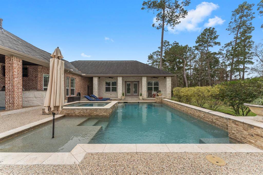 View of the pool and hot tub leading to the pool side entrance to the Guest Home.