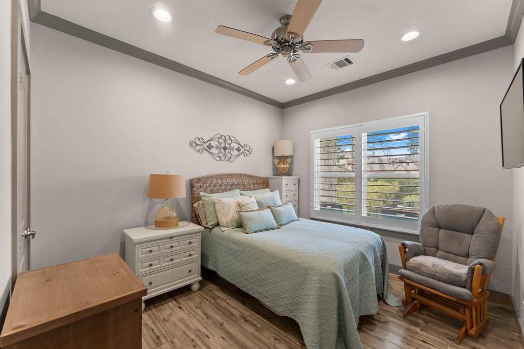 The bedroom in the Guest Home offers a great view of the backyard and luxury pool.