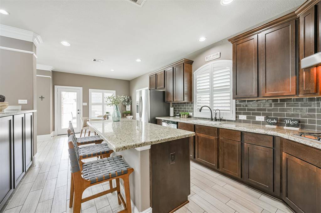 Chef's Eat-In Island Kitchen Features Granite Countertops, Stainless Steel Appliances and 42" Cabinets with Crown Molding
