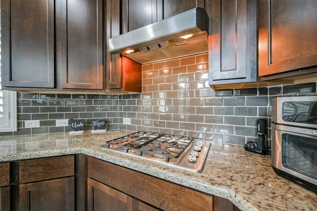 Chef's Eat-In Island Kitchen Features Granite Countertops, Stainless Steel Appliances and 42" Cabinets with Crown Molding