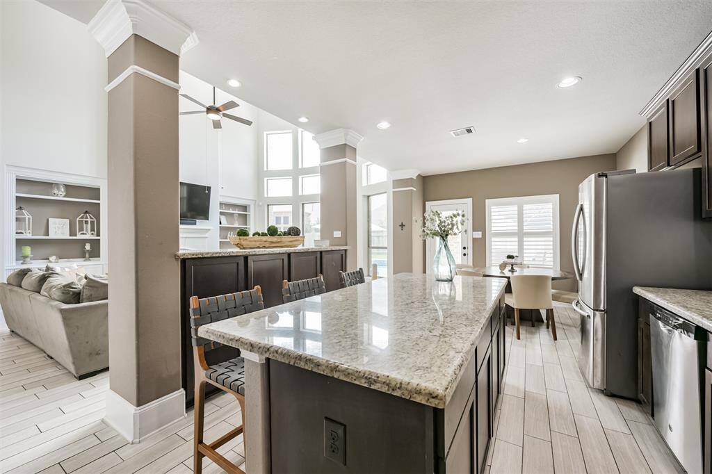 Chef's Eat-In Island Kitchen Features Granite Countertops, Stainless Steel Appliances and 42" Cabinets with Crown Molding