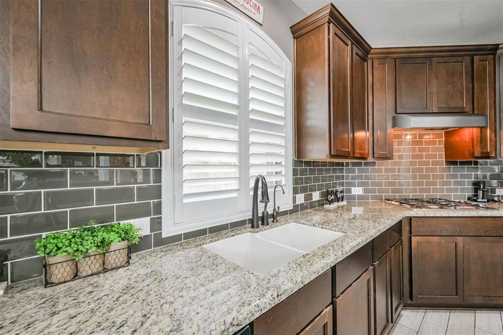Chef's Eat-In Island Kitchen Features Granite Countertops, Stainless Steel Appliances and 42" Cabinets with Crown Molding