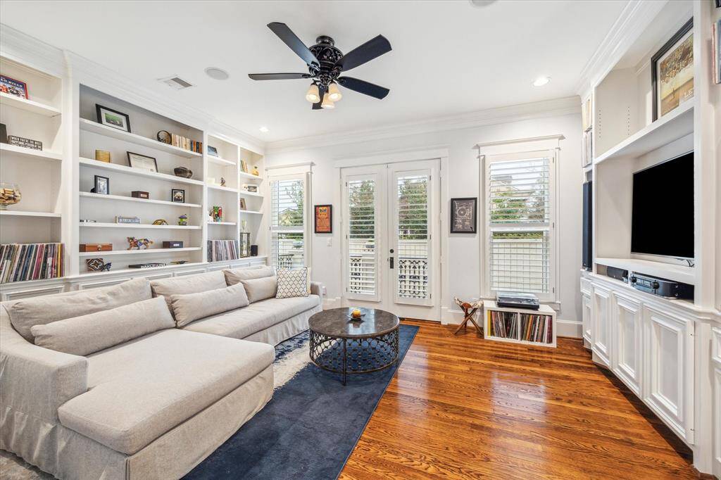 The family room, situated on the first floor, showcases custom built-ins with plenty of storage, surround sound and direct access to a porch that opens to the beautiful backyard.
