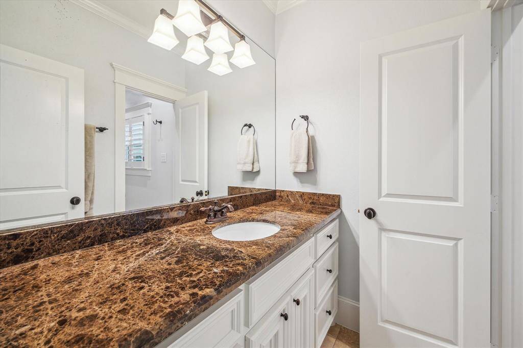 The two secondary bedrooms are connected by a shared bath, thoughtfully designed to provide each room with its own vanity space.