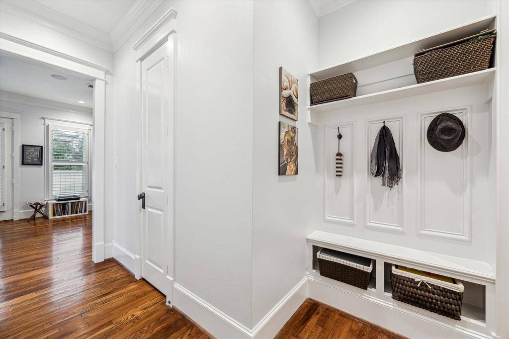 A drop zone! This space is the key to an organized life, with hooks for hats and bags and space for baskets to catch shoes and accessories. The door leads to a powder bath