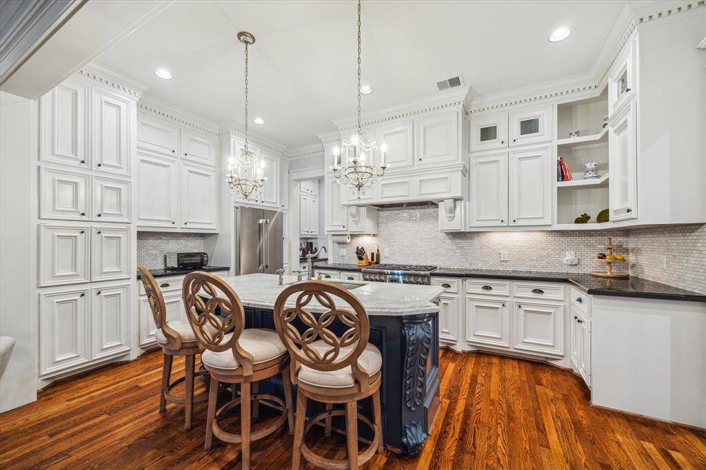 Stunning kitchen equipped with a high end Thermador 6-burner gas range with convection and gas oven, along with a matching Thermador refrigerator and dishwasher, all installed in 2024 for modern convenience and elegance.