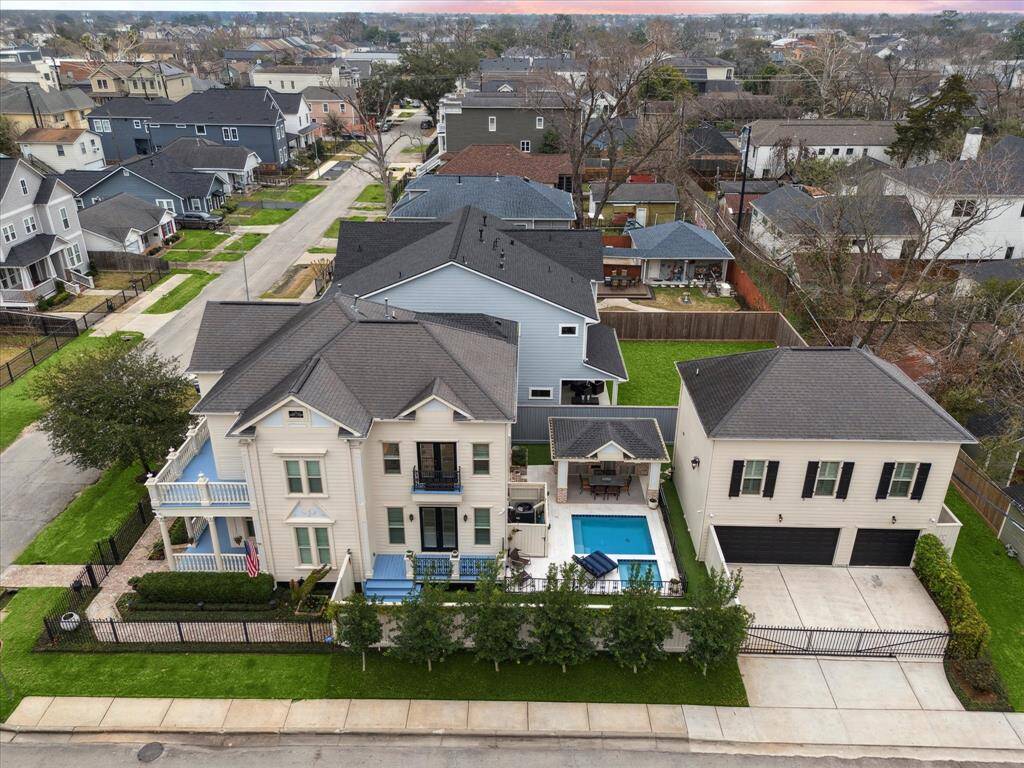 View of the property and the 3-car garage with driveway gate.