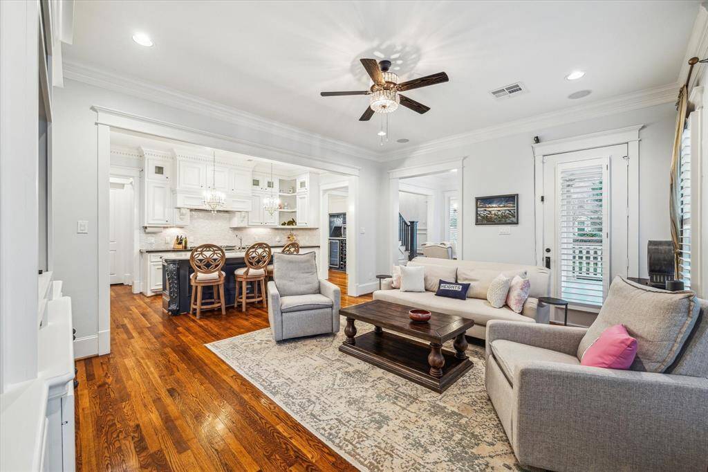 The living room features cased openings to the kitchen and dining room, along with direct access to the front porch, making entertaining effortless.