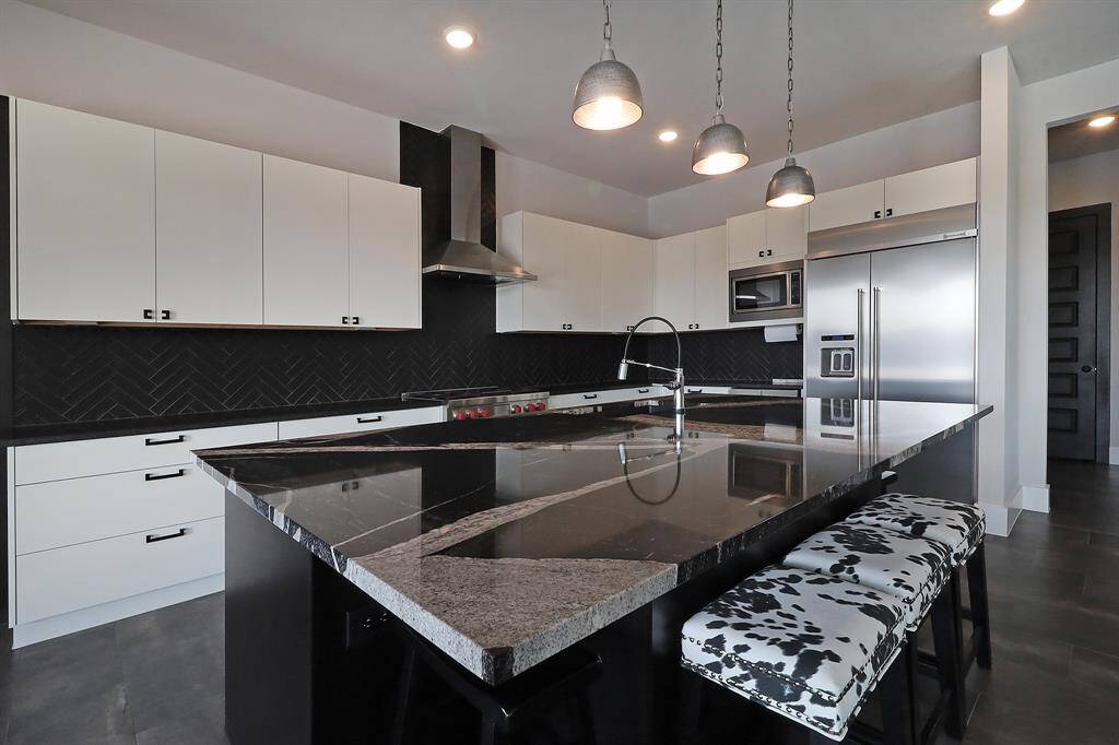 Custom ordered granite island in gourmet kitchen.