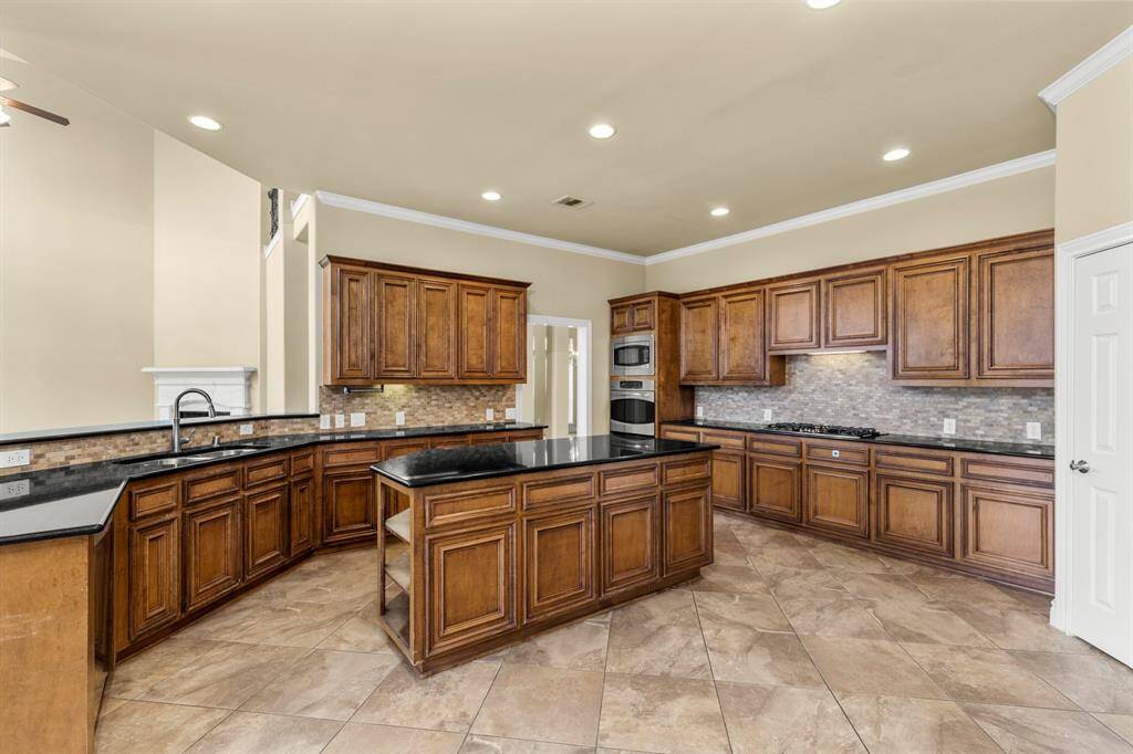 ISLAND KITCHEN WITH LONG COUNTERS AND GENEROUS CABINET SPACE