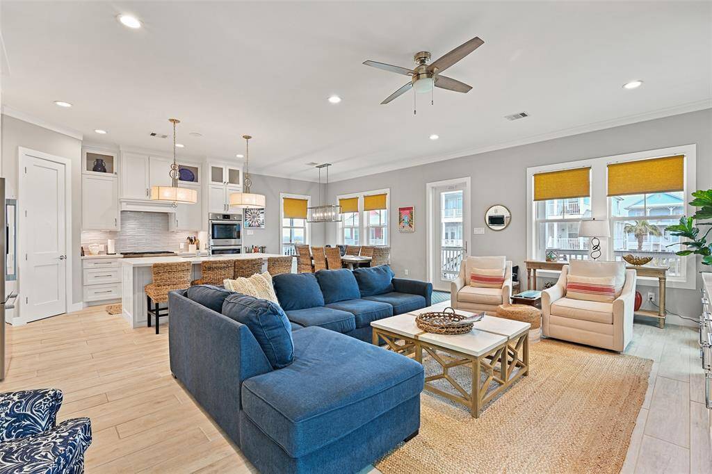 Light-filled open-concept living area with large windows and breathtaking Gulf views.  Notice the BOSCH double oven and the extra storage in front of the isalnd.