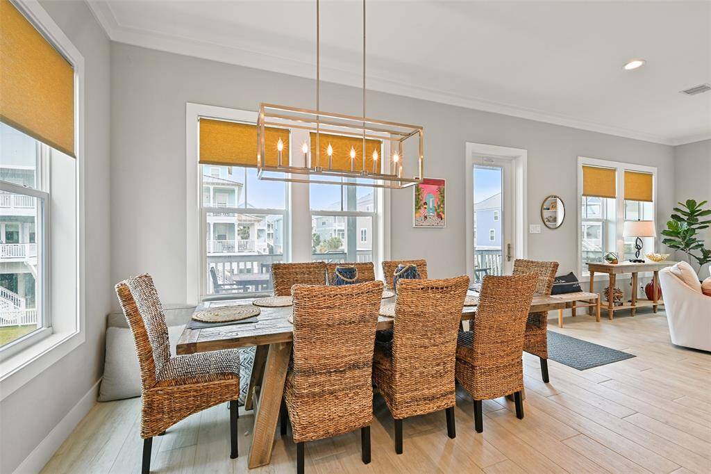 This dining area is sure to provide the perfect setting for meals that make memories.  The door leads to outdoor dining on the beautiful Trex decking.  Notice the seagrass window coverings throughout.