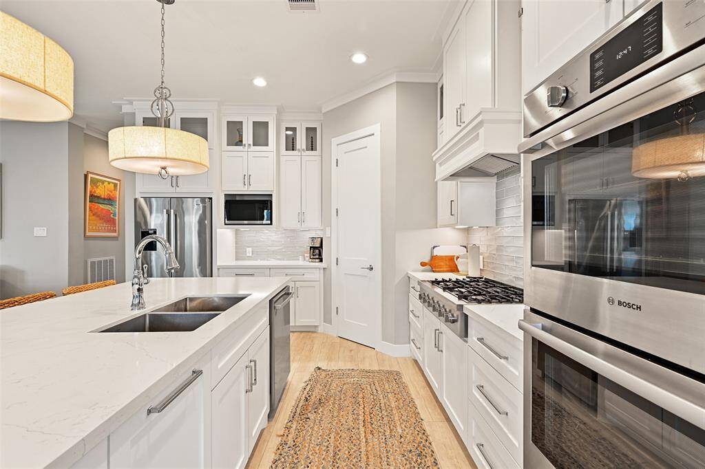 Abundant storage space with a walk-in pantry, soft-close cabinets, and designer hardware.
