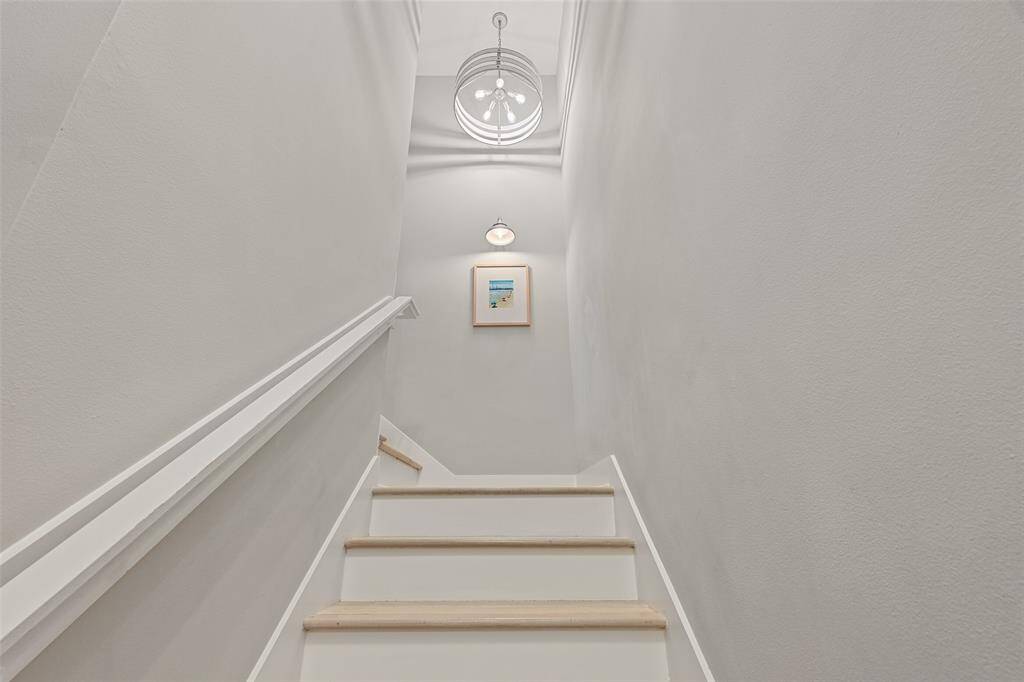 The modern coastal aesthetic continues up the stairs to the top floor.
