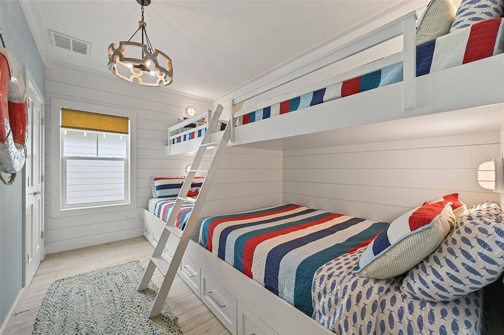 Another view of the bunk room. Notice the nautical lighting and the shiplap detail.  This is a very comfortable room for adults and children alike.  This would be perfect for a short term rental opportunity.