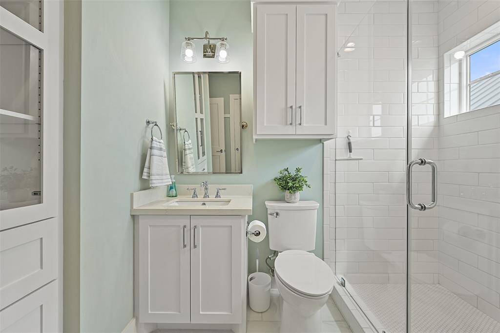 This is the bathroom off one of the upstairs bedroom.  It also has hall access to share with the bunkroom gursts. Modern fixtures with designer touches in every bathroom including ample storage in the built in's.
