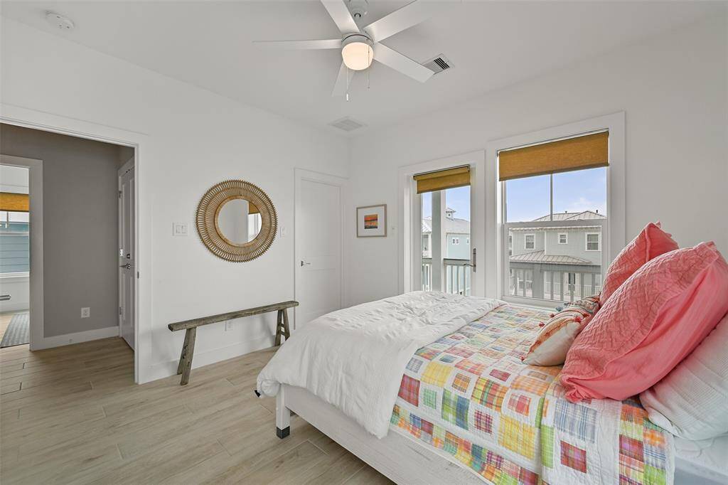 Another view of the guest bedroom upstairs. Take your morning coffee out onto the top deck patio to enjoy the sunsets and the gulf breeze!  there is a large walk in closet as well.