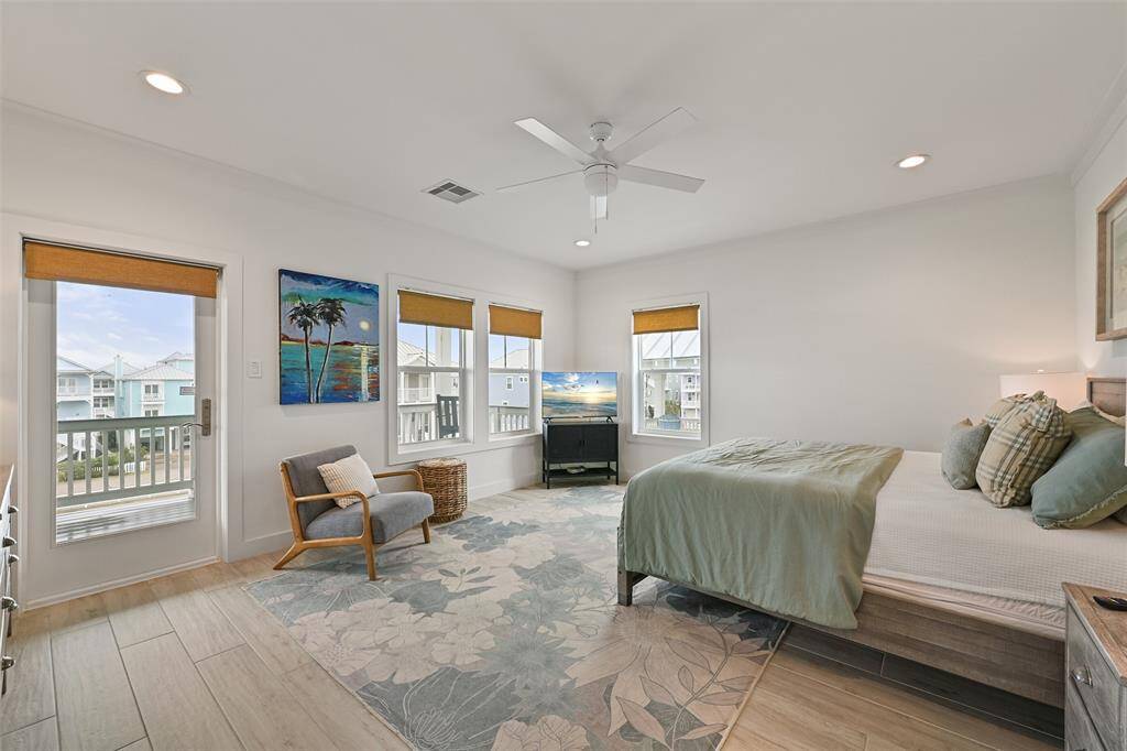 An owner's retreat, wake up to ocean views from the serene primary bedroom.  This large 18x15 room offers a luxurious feel.  The door leads to the deck with amazing views.