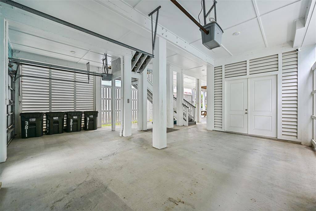 Plenty of room for beach gear, golf carts, and storage on the ground floor garage area. It's functional design offers ample storage space to keep everything organized for coastal living.  Notice the brick near the stairs- this is the platform for an ELEVATOR install.