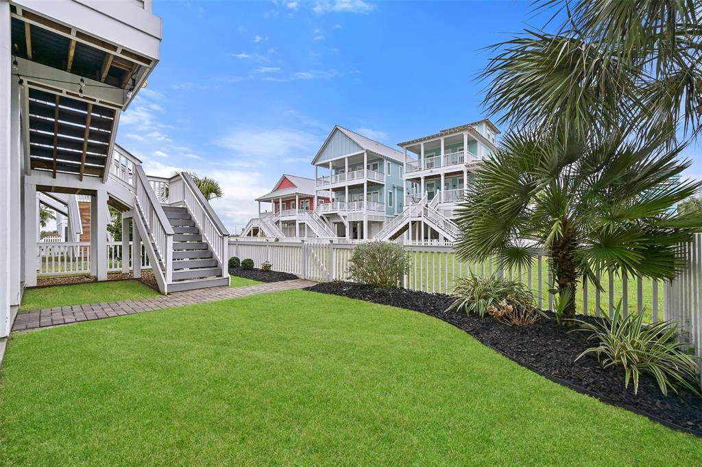 The expansive living room can accommodate all your entertainment and relaxation needs.  Notice the wood look tile flooring which is an upgrade to handle the busiest foot traffic from summer fun beach days.