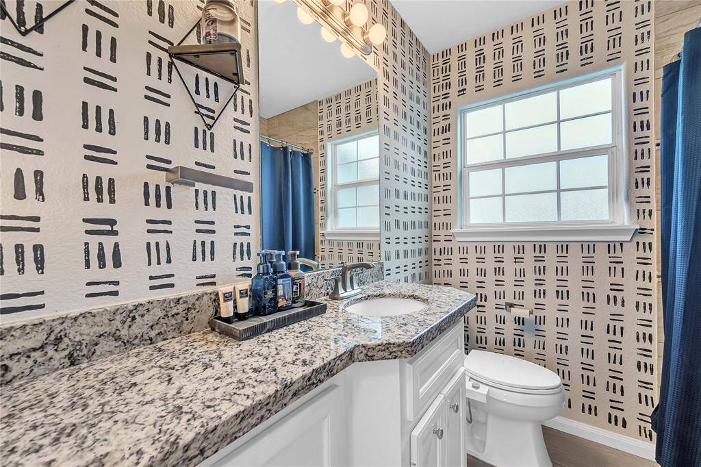 Secondary bath with granite counter tops.