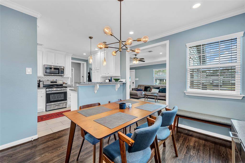 Just off the kitchen is the dining room with modern lighting and hardwood floors.