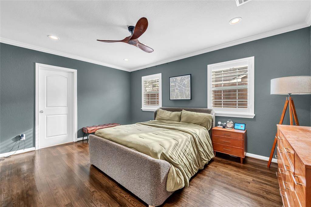 Primary suite is spacious and bright with hardwood floors and ensuite bath with walk-in closet.