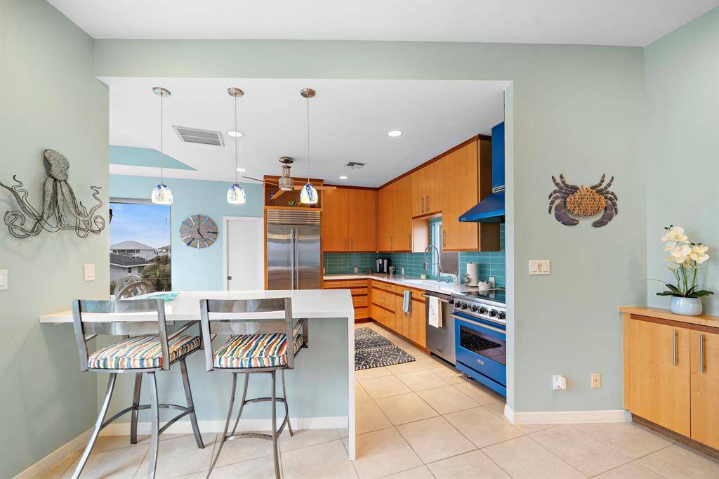 Open concept, remodeled gourmet kitchen with quartz countertops.