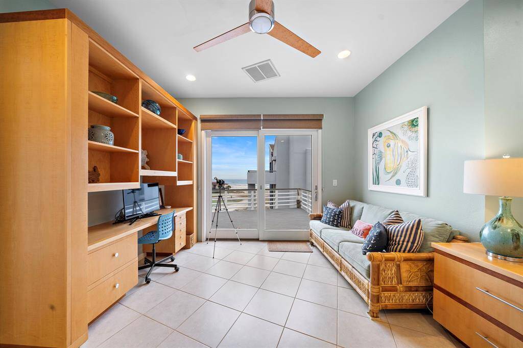 Home office/study with built in workspace (or gaming center? With access to the patio. Tommy Bahama sleeper sofa offers an instant guest room.