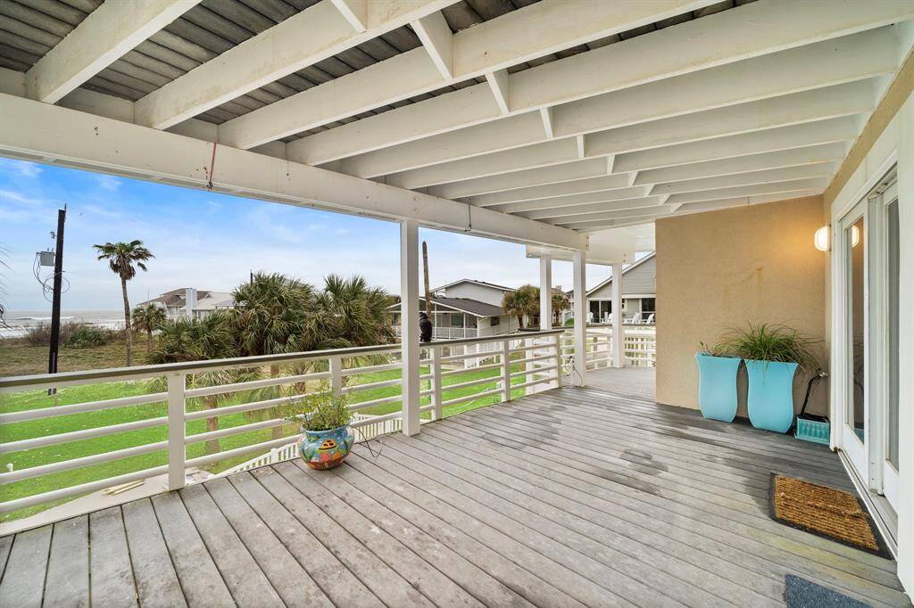 Expansive covered decking off the bedroom level (2nd Floor).  Planters are excluded.