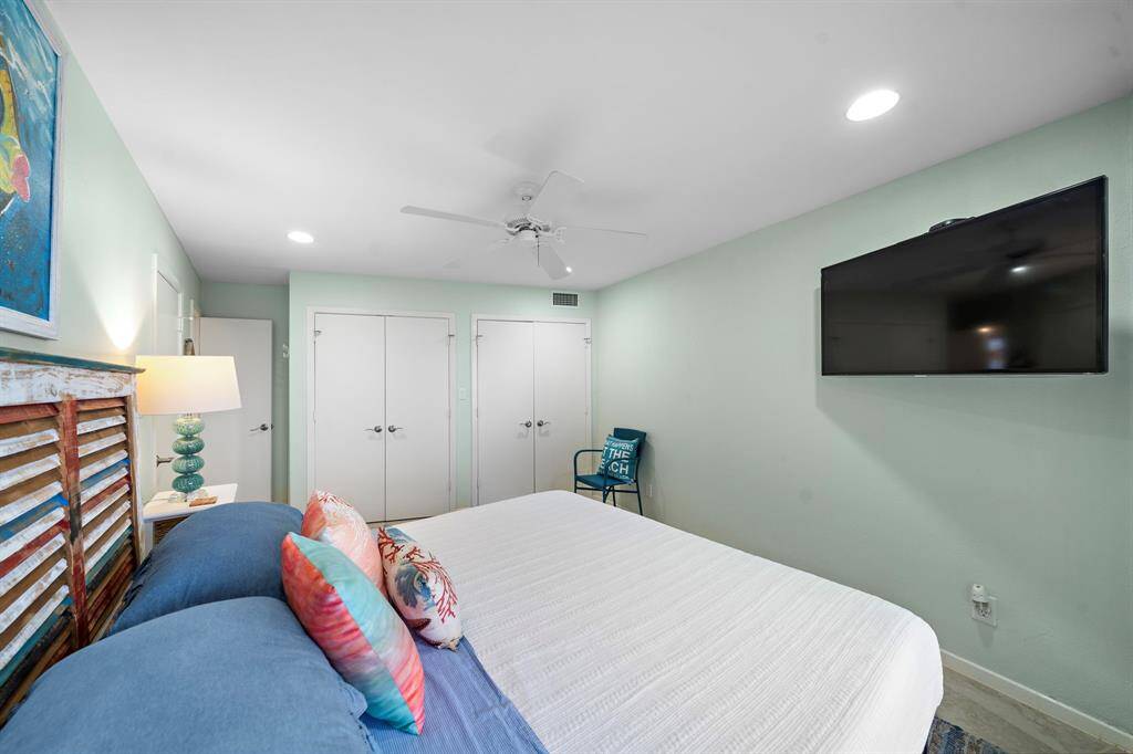 One of the 3 guest bedrooms with TV and views of the beach.