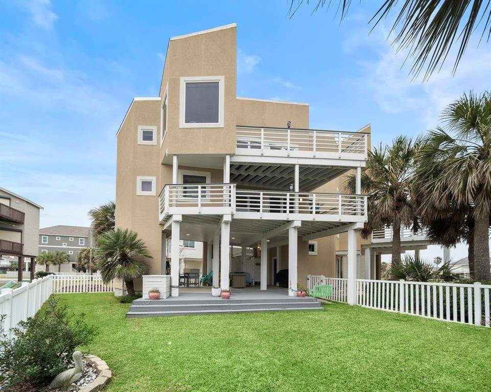 Fully fenced backyard with trex decking and sprinkler system. Decks on every floor to enjoy the views and ocean breeze! (Colored pots and white bin are excluded)