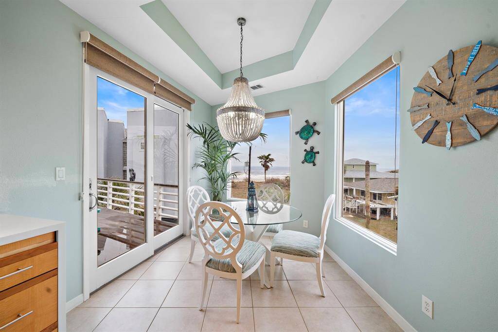 Breakfast room with a view.  Coastal decor and chandelier, and custom shades.
