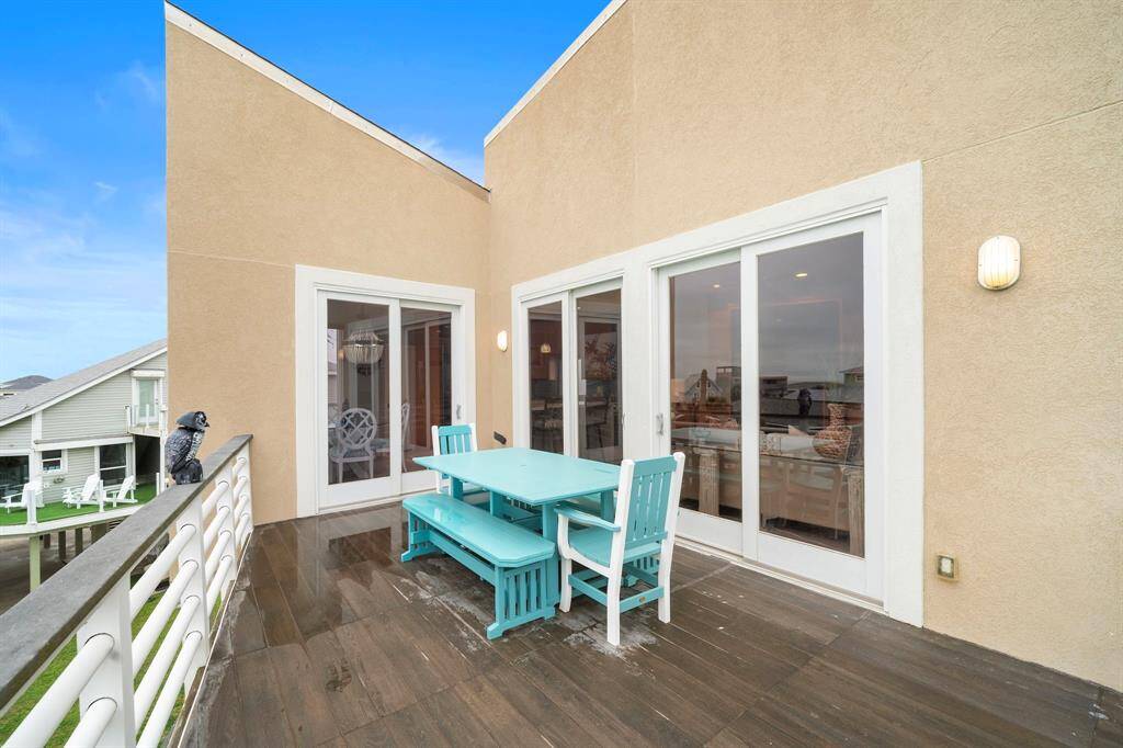 This deck is tiled over trex decking and is off the living and breakfast/kitchen.  The polywood table and chairs are ready for dining alfresco.